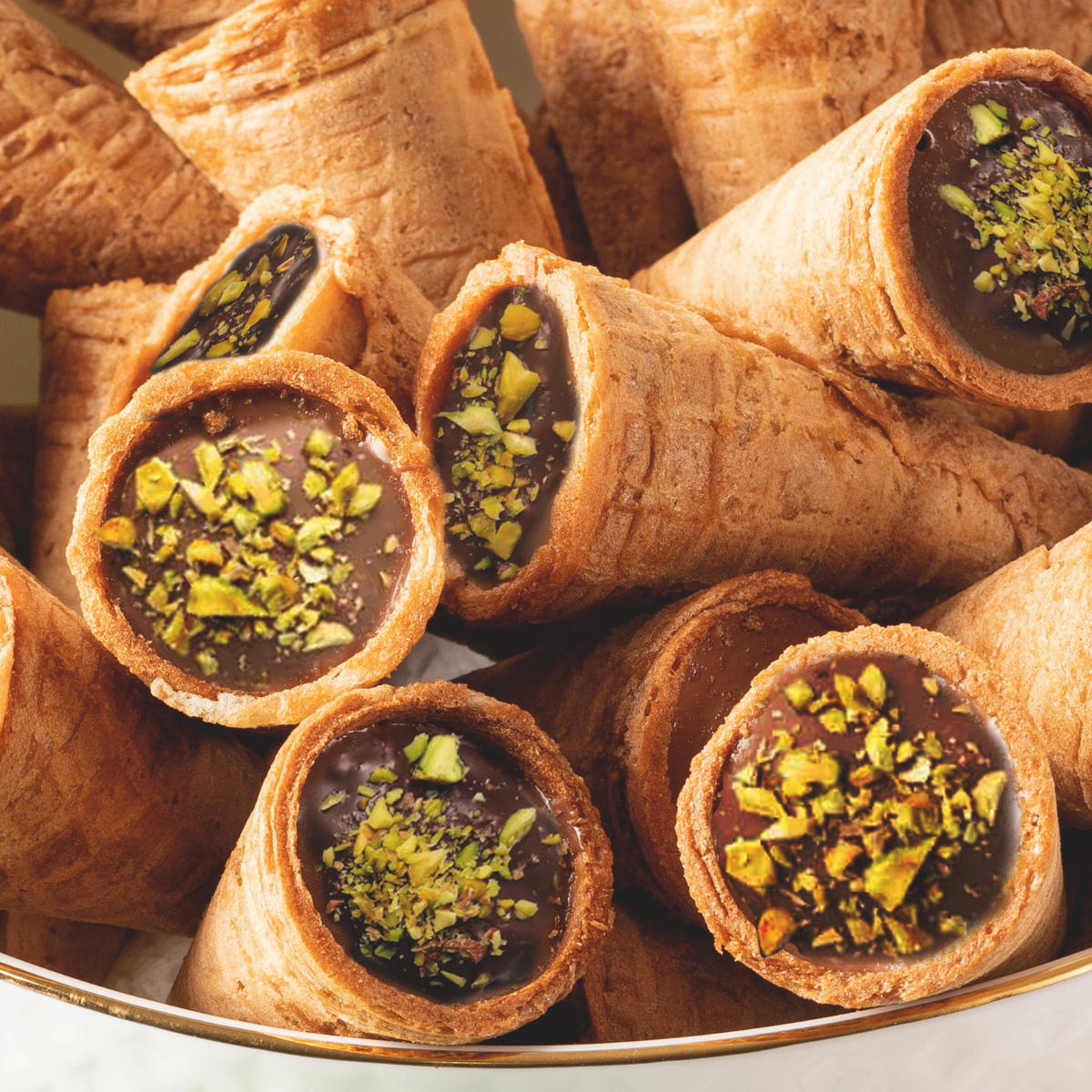 Pistachio-filled Dubai Chocolate cones on a white plate